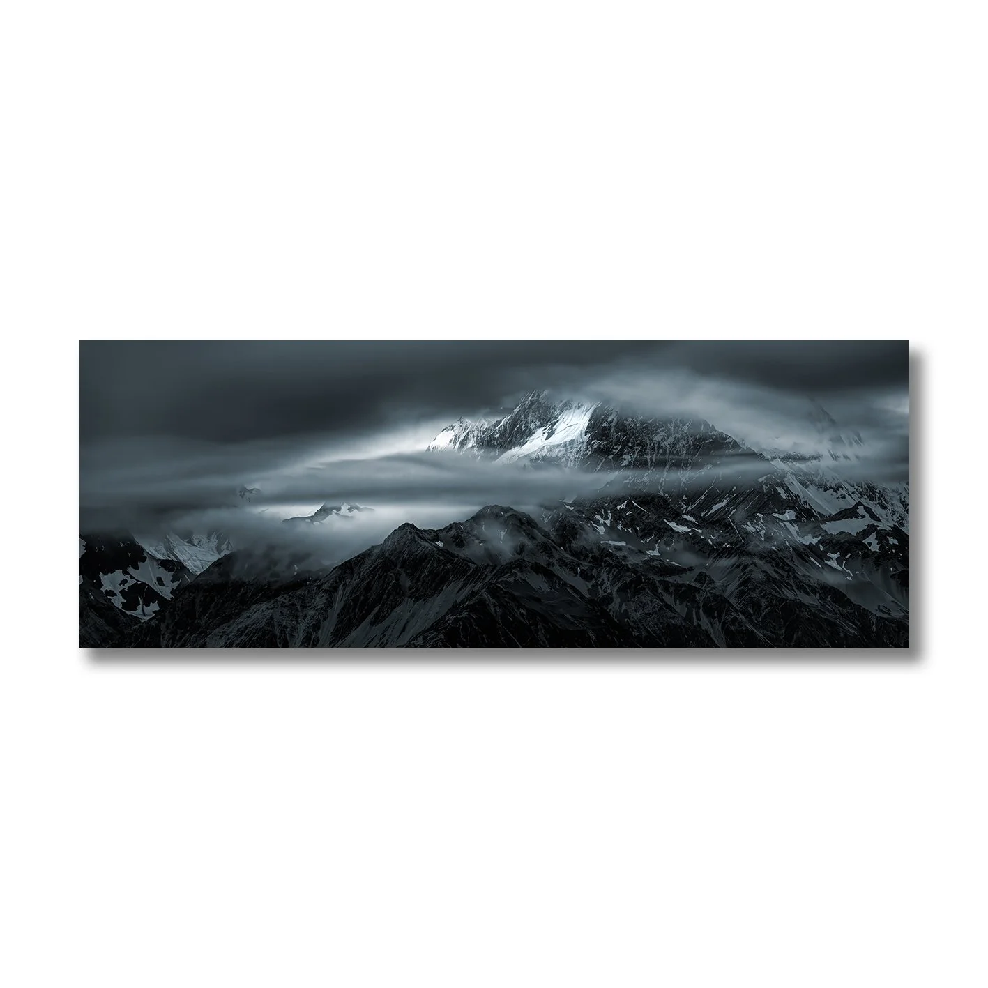 Moody photograph of snow-covered Southern Alps and drifting cloud near Glentanner