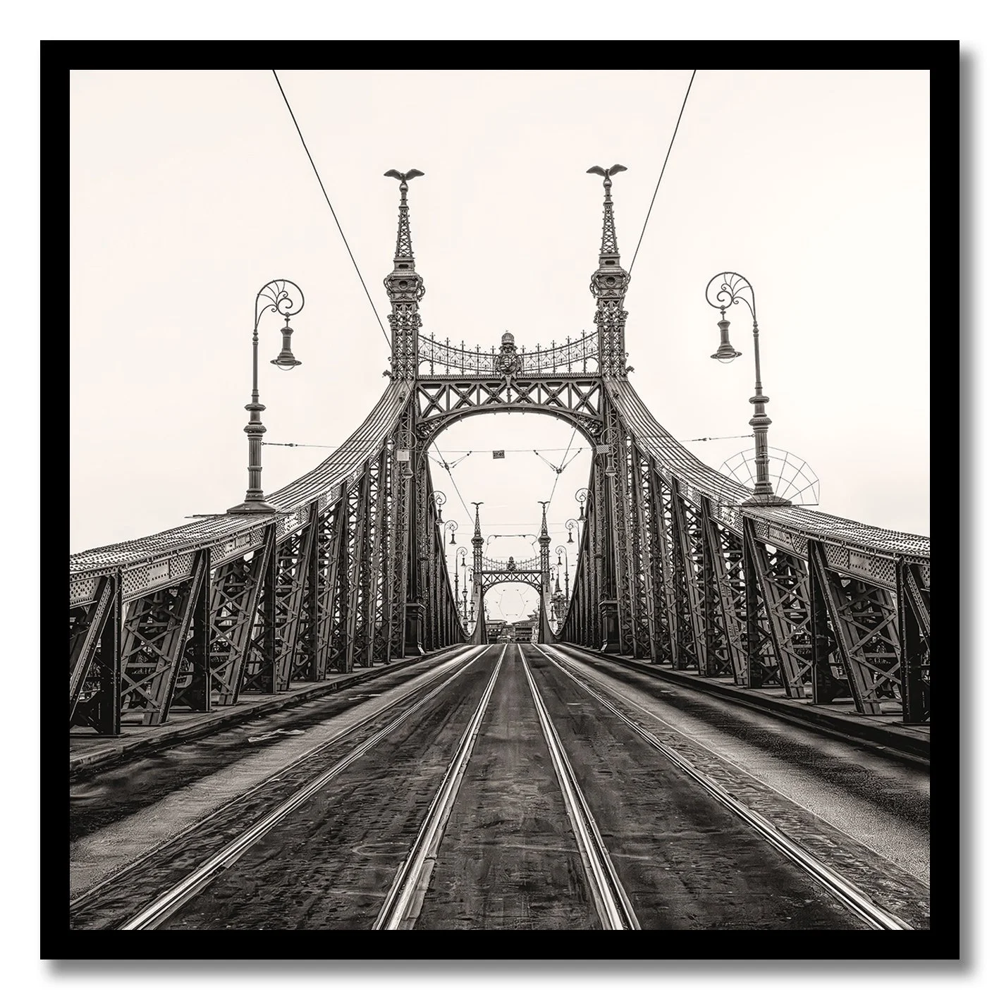 Black and white photograph of Liberty Bridge in Budapest with tramlines