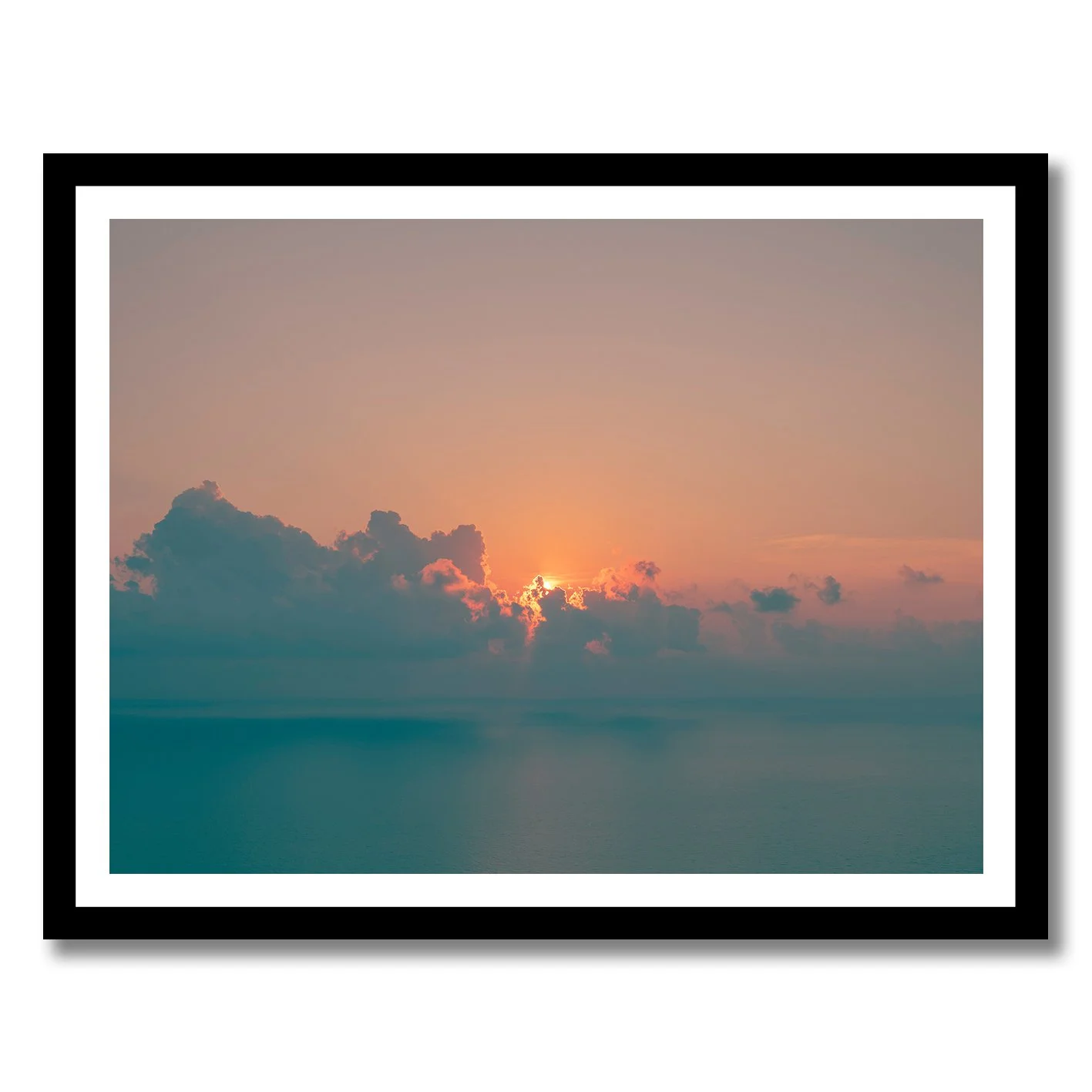 Sunrise seascape photograph with glowing horizon and soft clouds over calm ocean