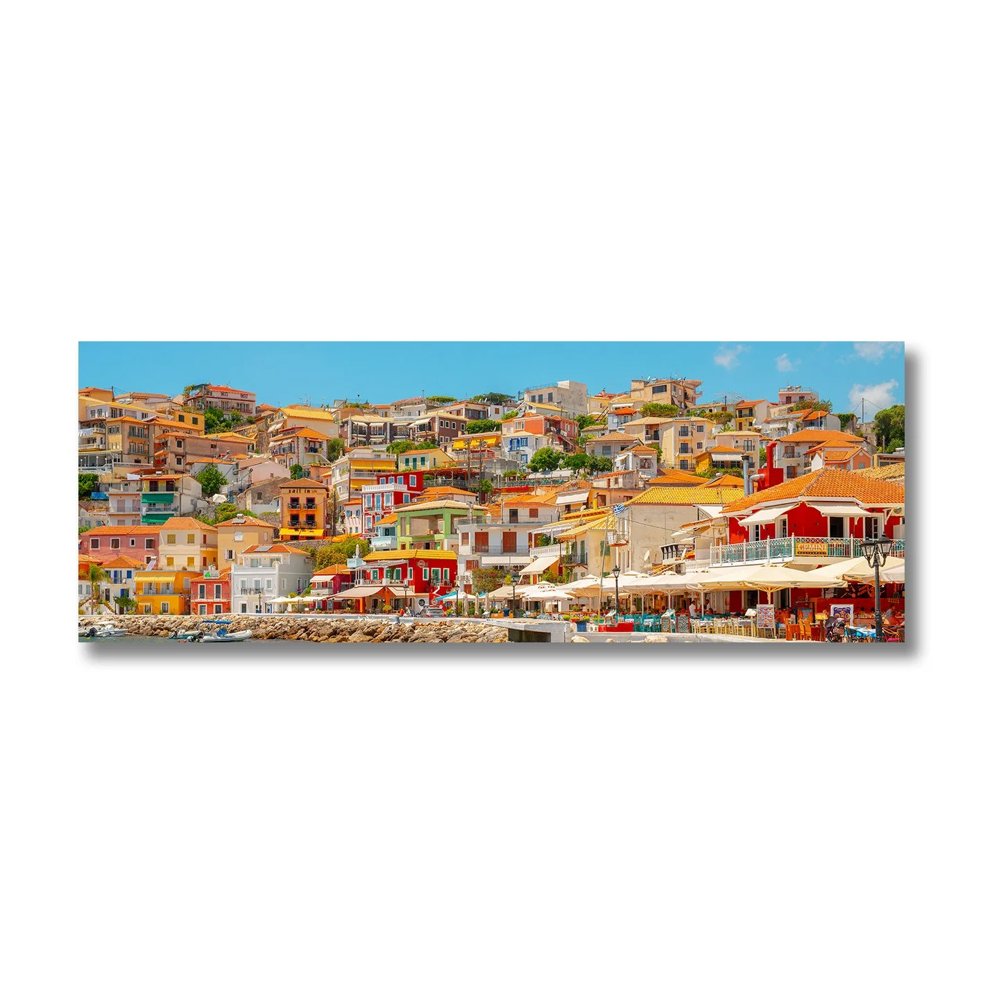 fine art photograph of colourful hillside buildings in parga greece under clear blue sky