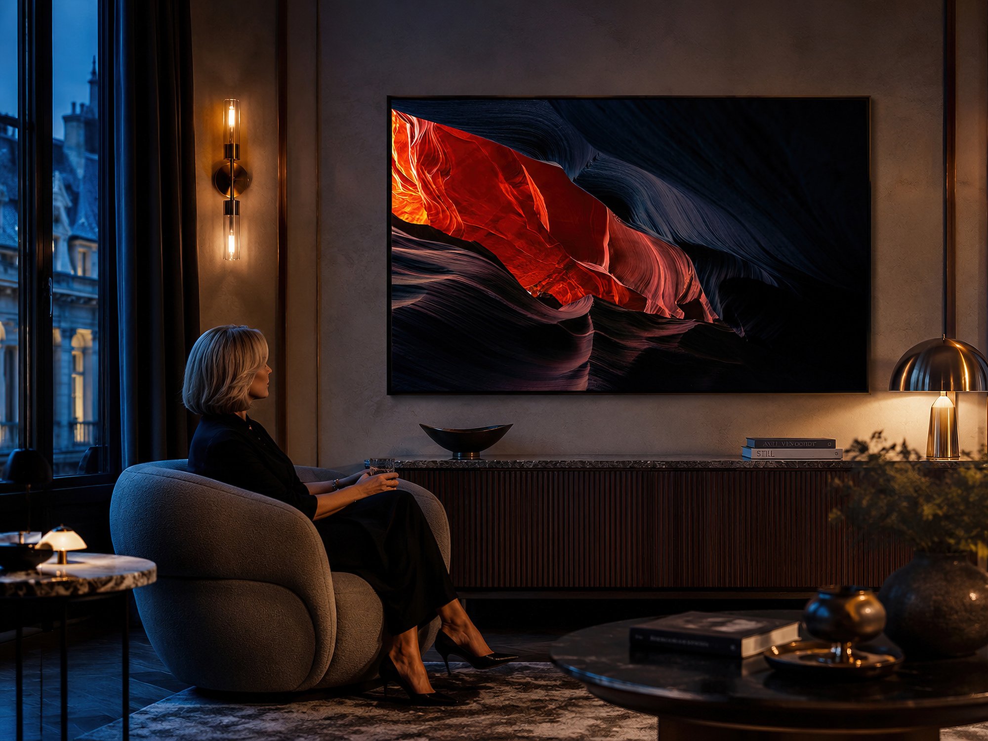 Framed Antelope Canyon photograph displayed without a white border in a moody evening lounge with a seated woman.