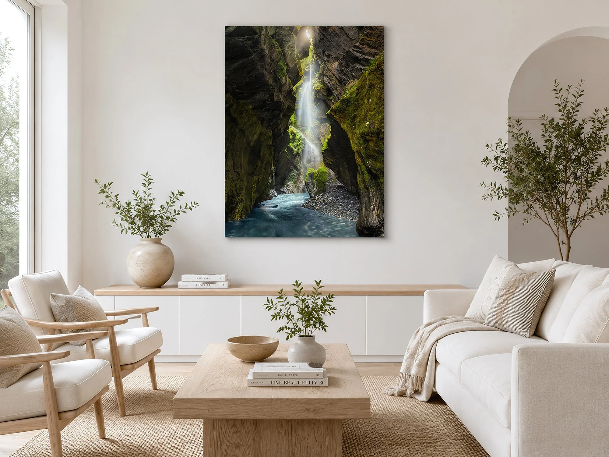 Canvas print of a canyon waterfall displayed in a bright Scandinavian living room with pale timber furniture and neutral decor by Nick Psomiadis at NIKART Studio and Gallery