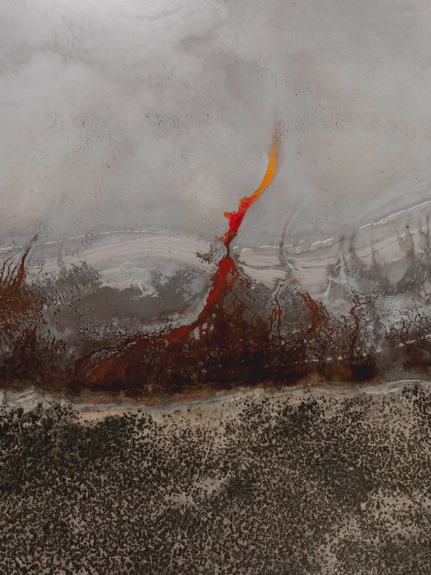 Abstract aerial landscape with red mineral flow and earthy textures, fine art photograph