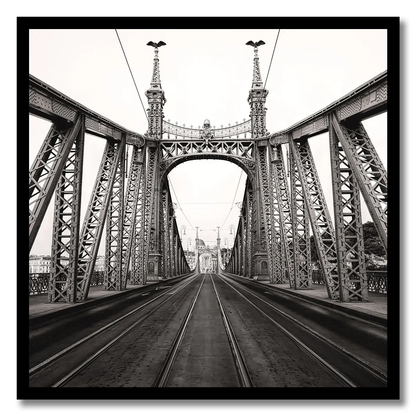 Black and white photograph of Liberty Bridge in Budapest with tramlines