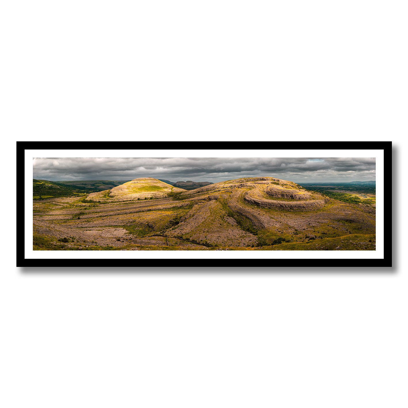 panoramic photograph of the burren limestone hills in ireland under dramatic clouds