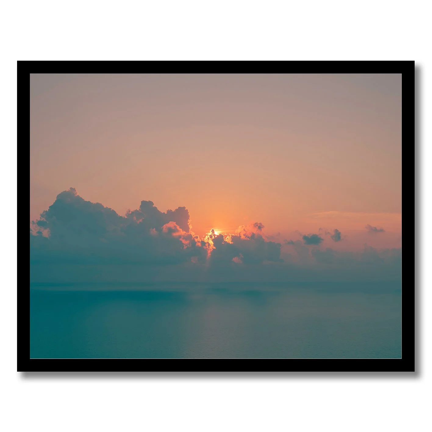 Sunrise seascape photograph with glowing horizon and soft clouds over calm ocean