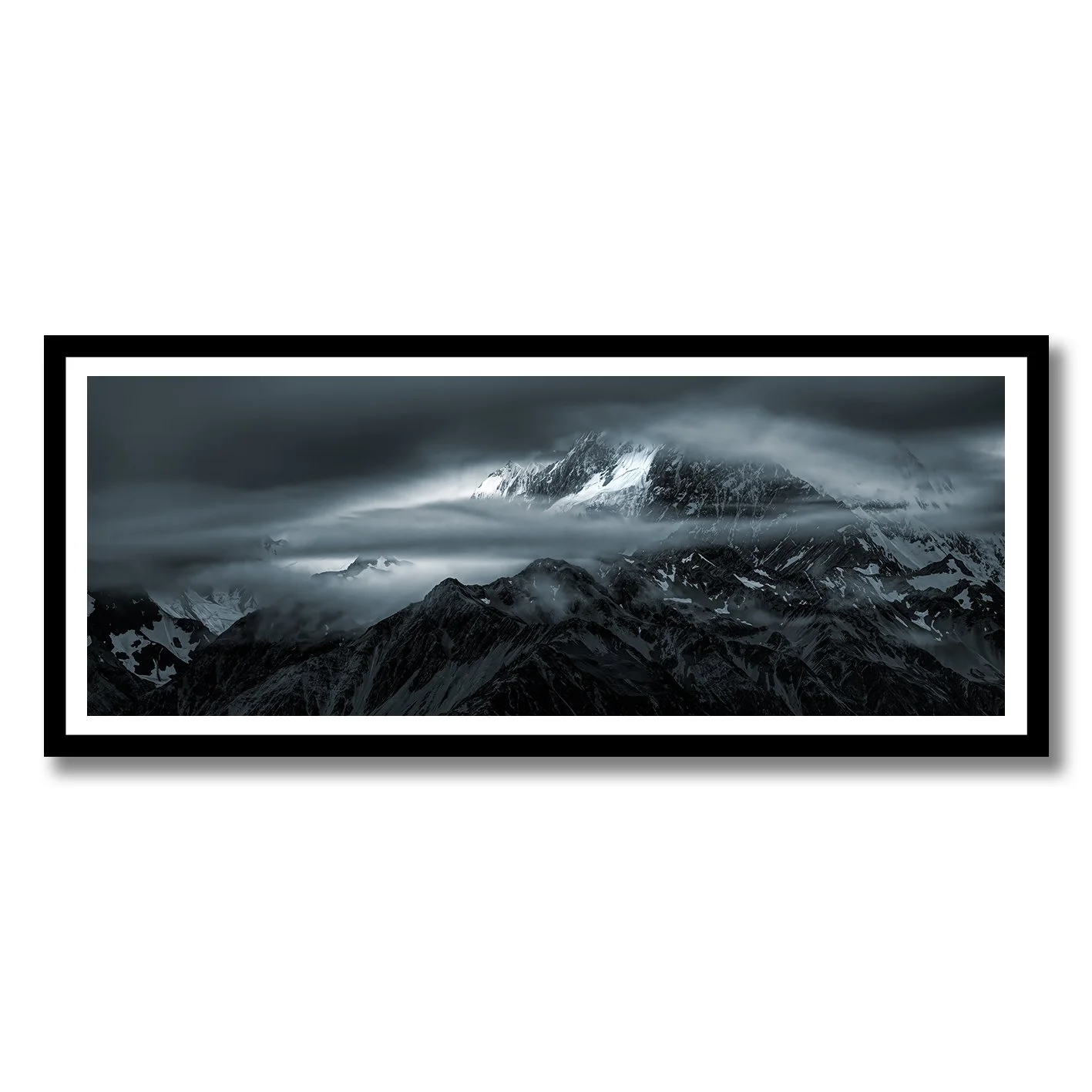 Moody photograph of snow-covered Southern Alps and drifting cloud near Glentanner