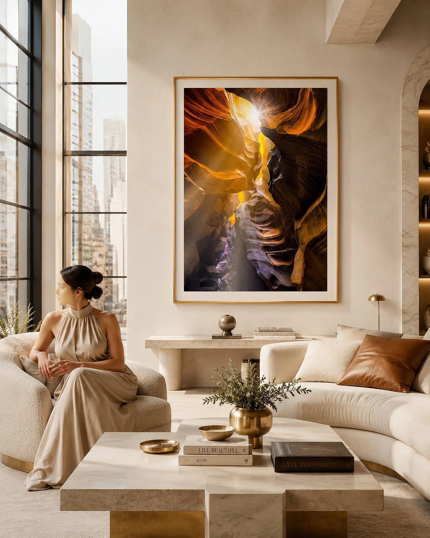 Gold-framed canyon photograph in a bright luxury loft with a seated woman by Nick Psomiadis at NIKART Studio and Gallery