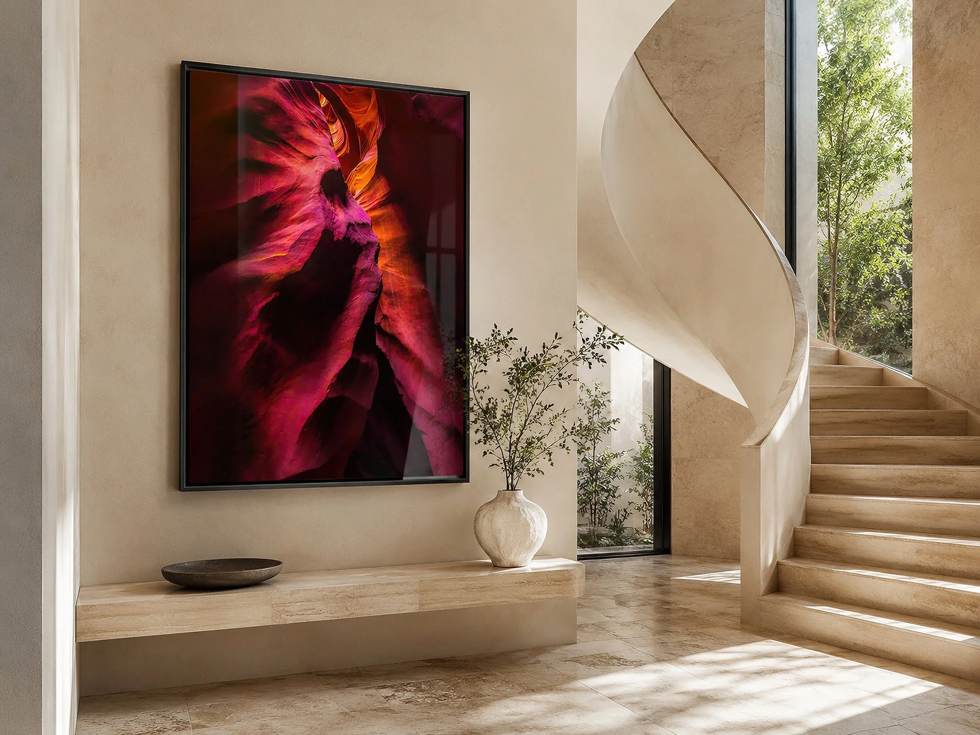 Framed Antelope Canyon photograph displayed behind subtly reflective glass in a bright Mediterranean-style foyer with a sculptural curved staircase, stone finishes and no people — Nick Psomiadis at NIKART Studio and Gallery.