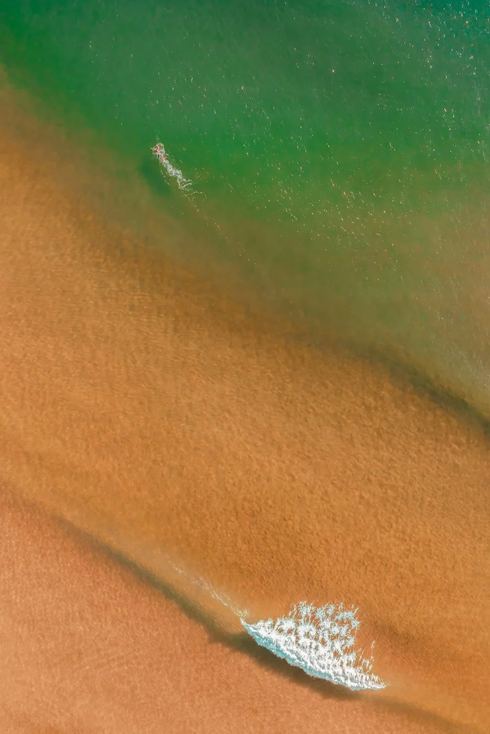 Aerial view of Mona Vale Beach with swimmer and waves, coastal photograph