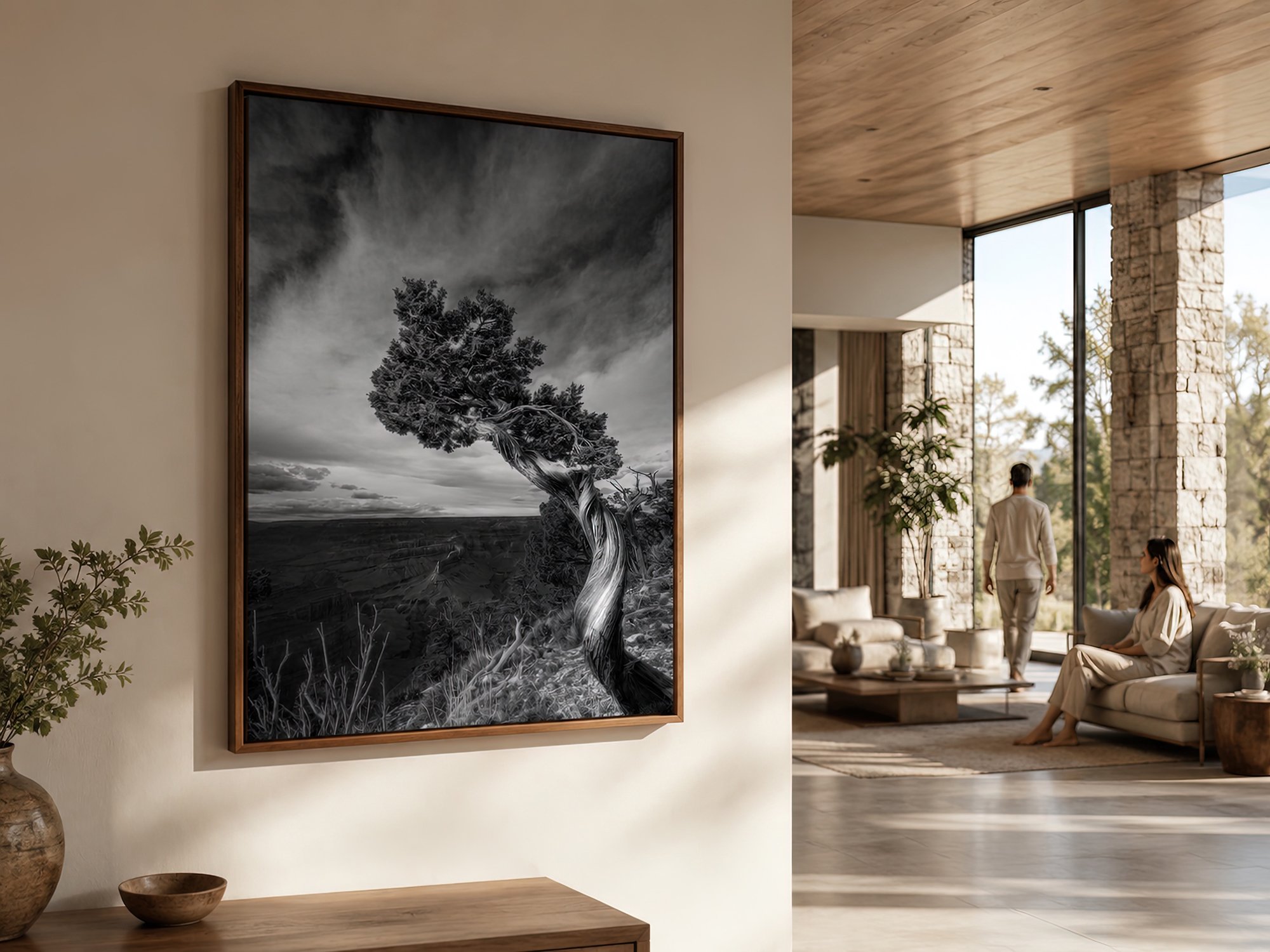 Bright spacious living room with a close-up timber-framed Grand Canyon tree photograph and two people in the sunlit background by Nick Psomiadis at NIKART Studio and Gallery