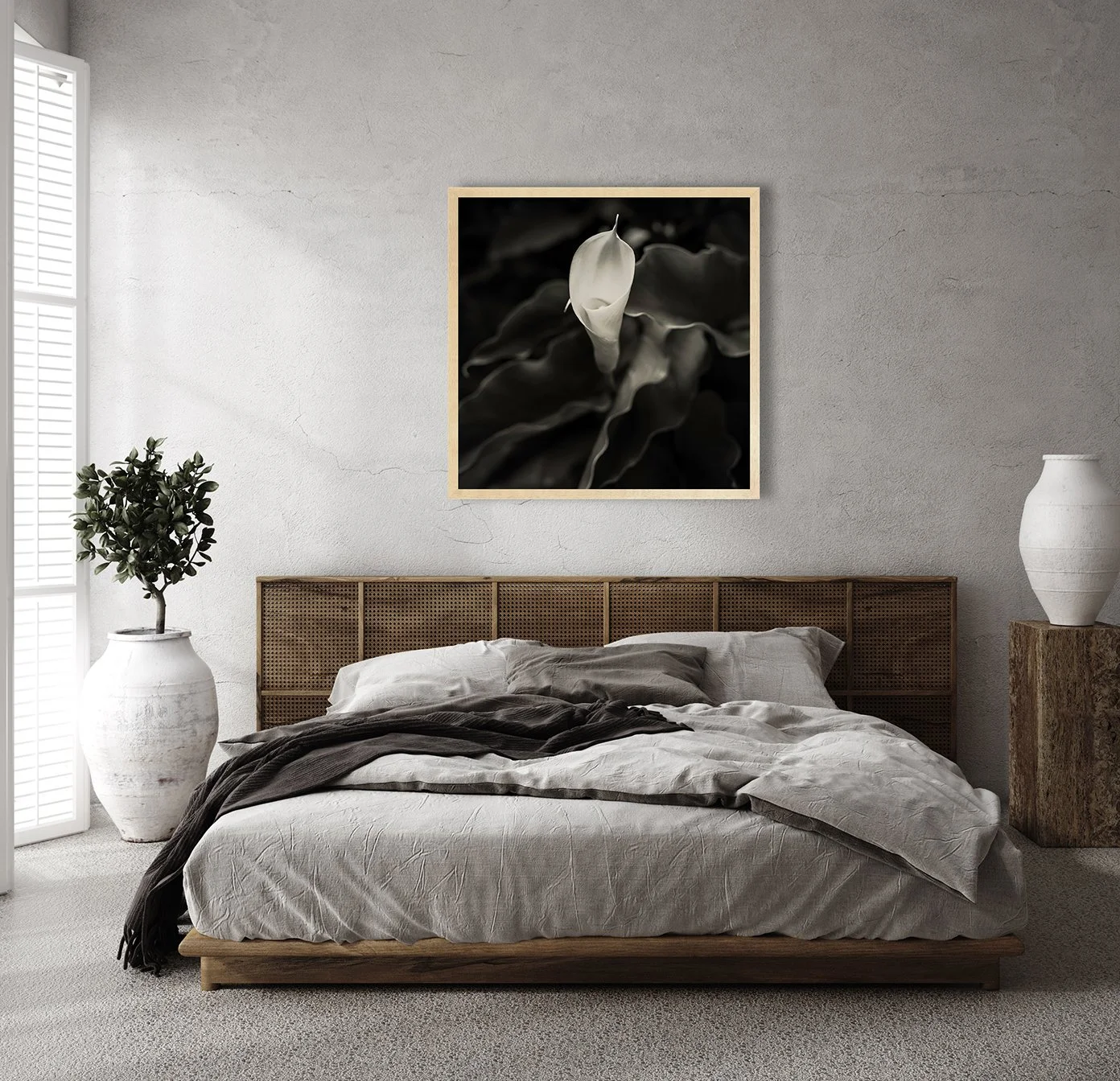 black and white photograph of a calla lily flower framed hanging in bedroom by nikart gallery