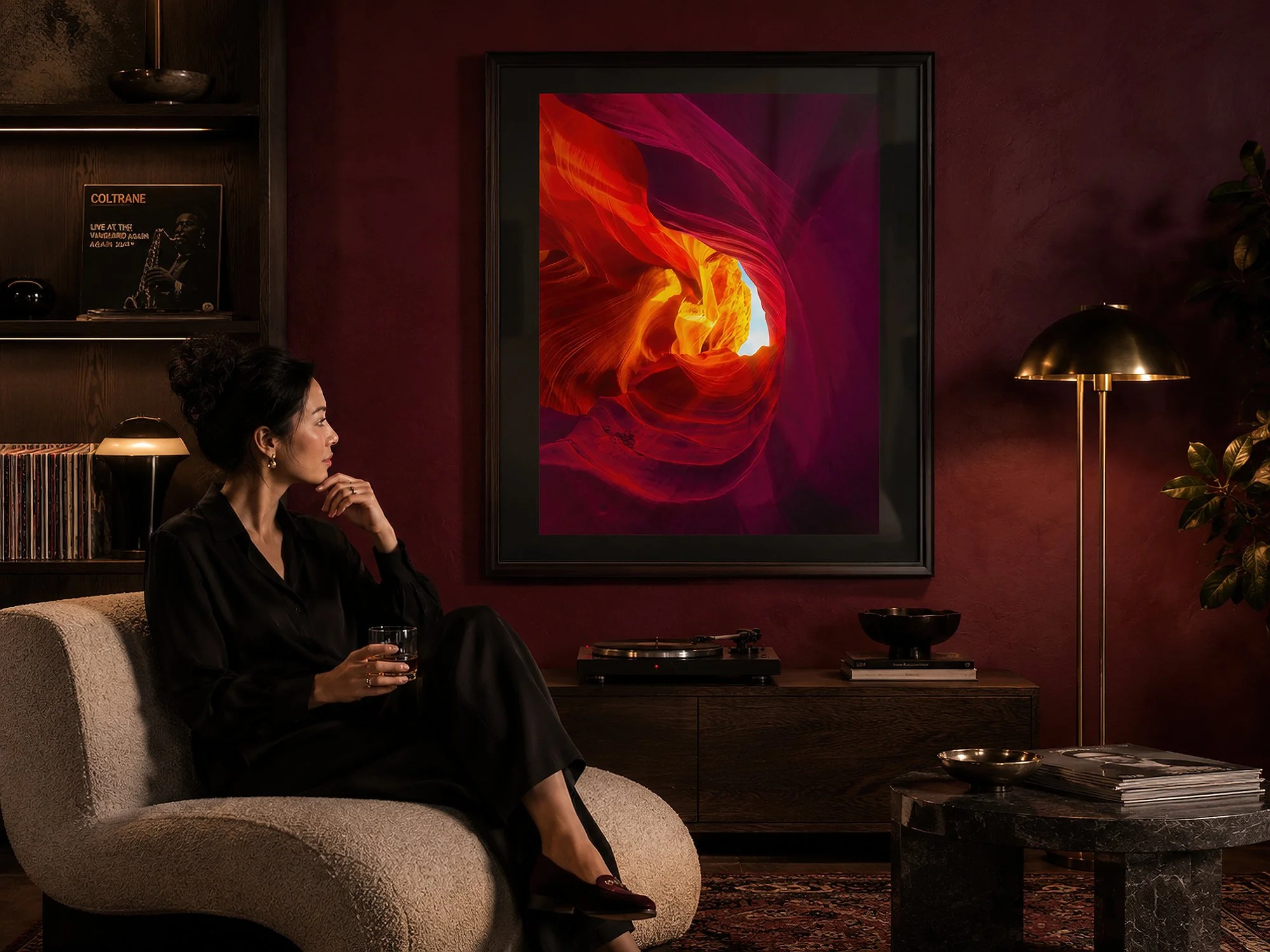 Framed Antelope Canyon photograph with a black mat displayed in a moody jazz listening room with burgundy walls, a turntable and a seated woman — Nick Psomiadis at NIKART Studio and Gallery.
