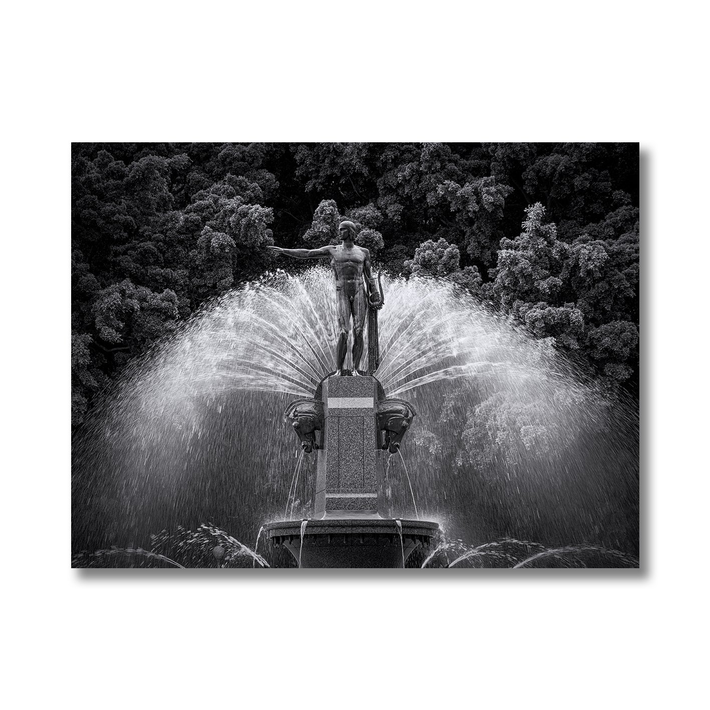 Black and white photograph of the Archibald Fountain statue with water spray in Hyde Park