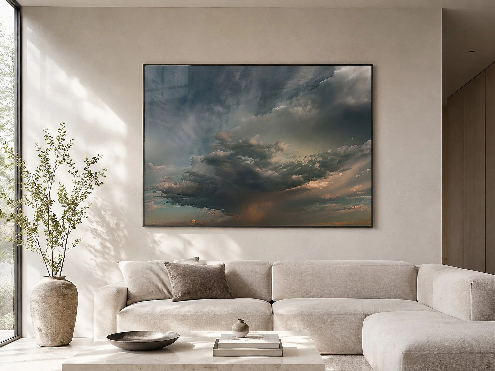 Bright modern minimalist living room with a framed dramatic storm cloud photograph above a cream sofa, styled with neutral furnishings, natural textures and soft daylight, by Nick Psomiadis at NIKART Studio and Gallery