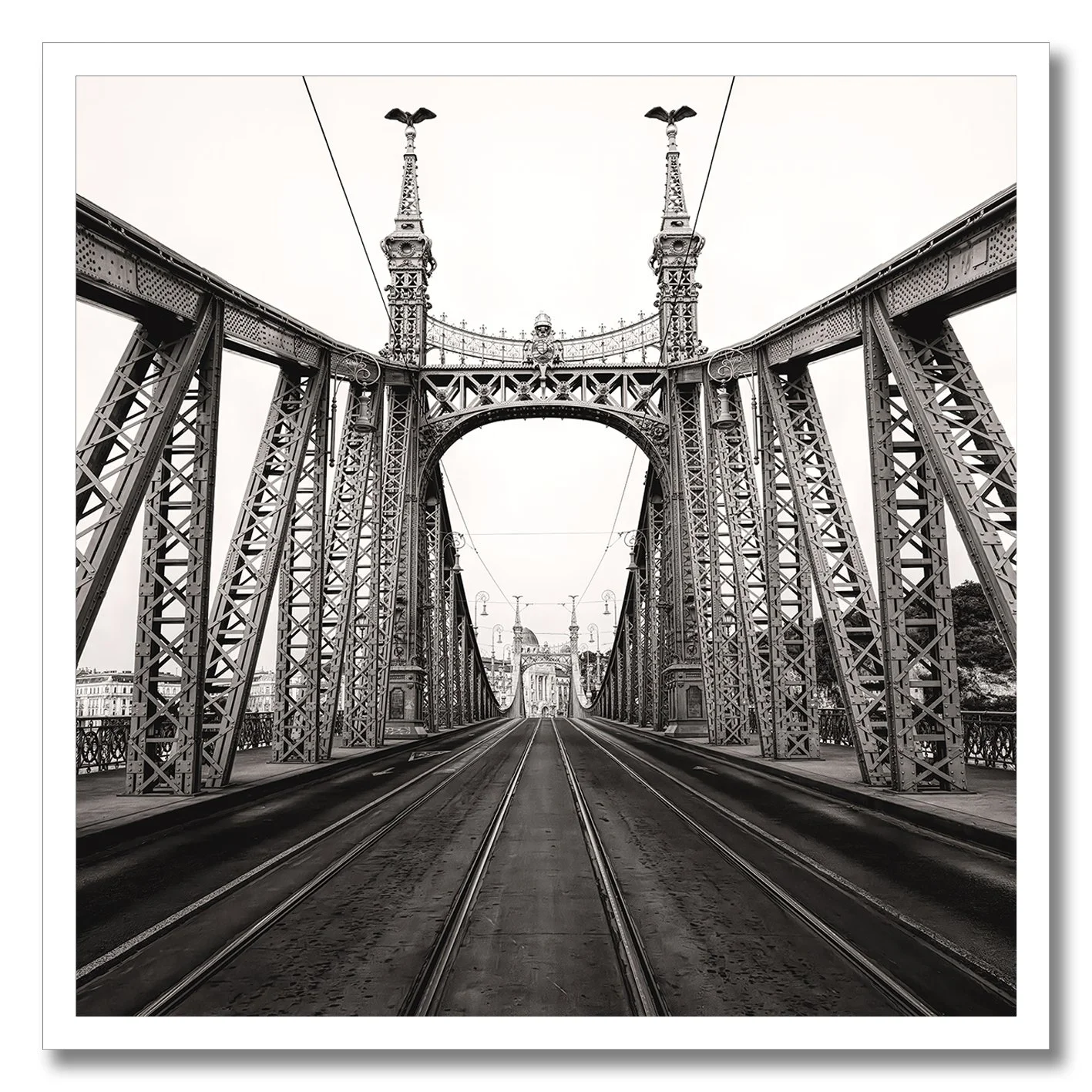 Black and white photograph of Liberty Bridge in Budapest with tramlines