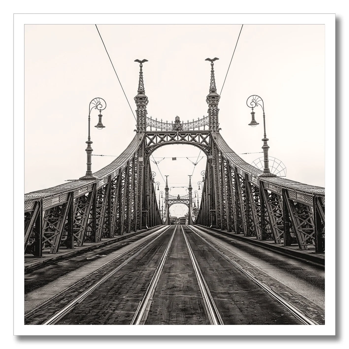 Black and white photograph of Liberty Bridge in Budapest with tramlines