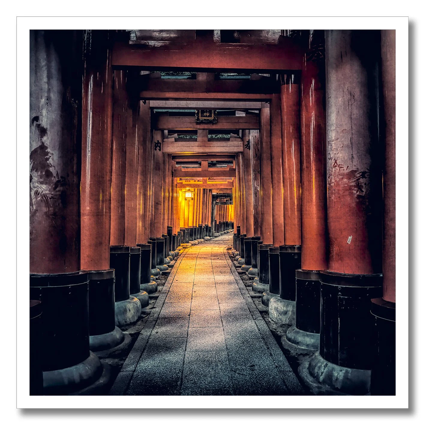 Fine art photograph of vermillion torii gates in Kyoto with warm light and grunge tones