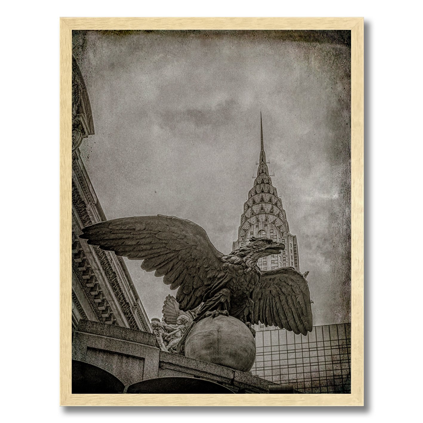 black and white photograph of grand central eagle with chrysler building behind
