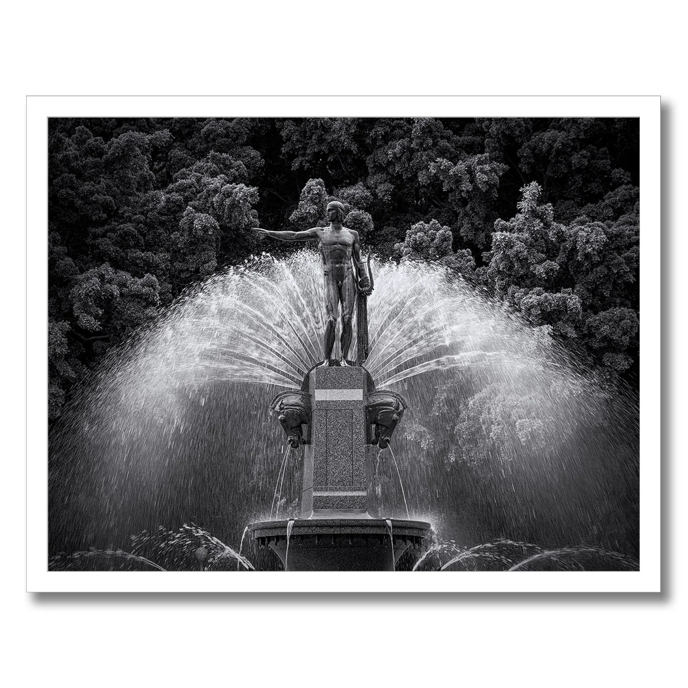 Black and white photograph of the Archibald Fountain statue with water spray in Hyde Park