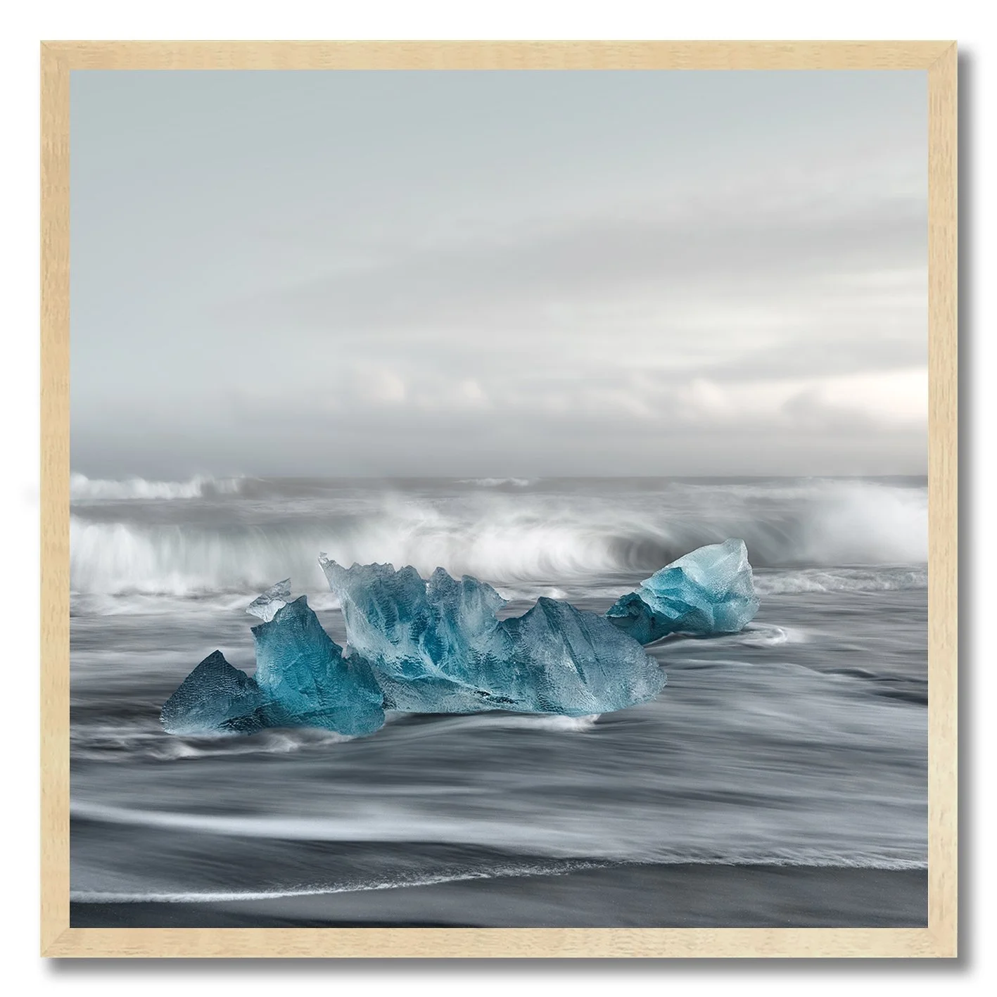 Fine art photograph of blue ice on Ice Beach with waves in Iceland