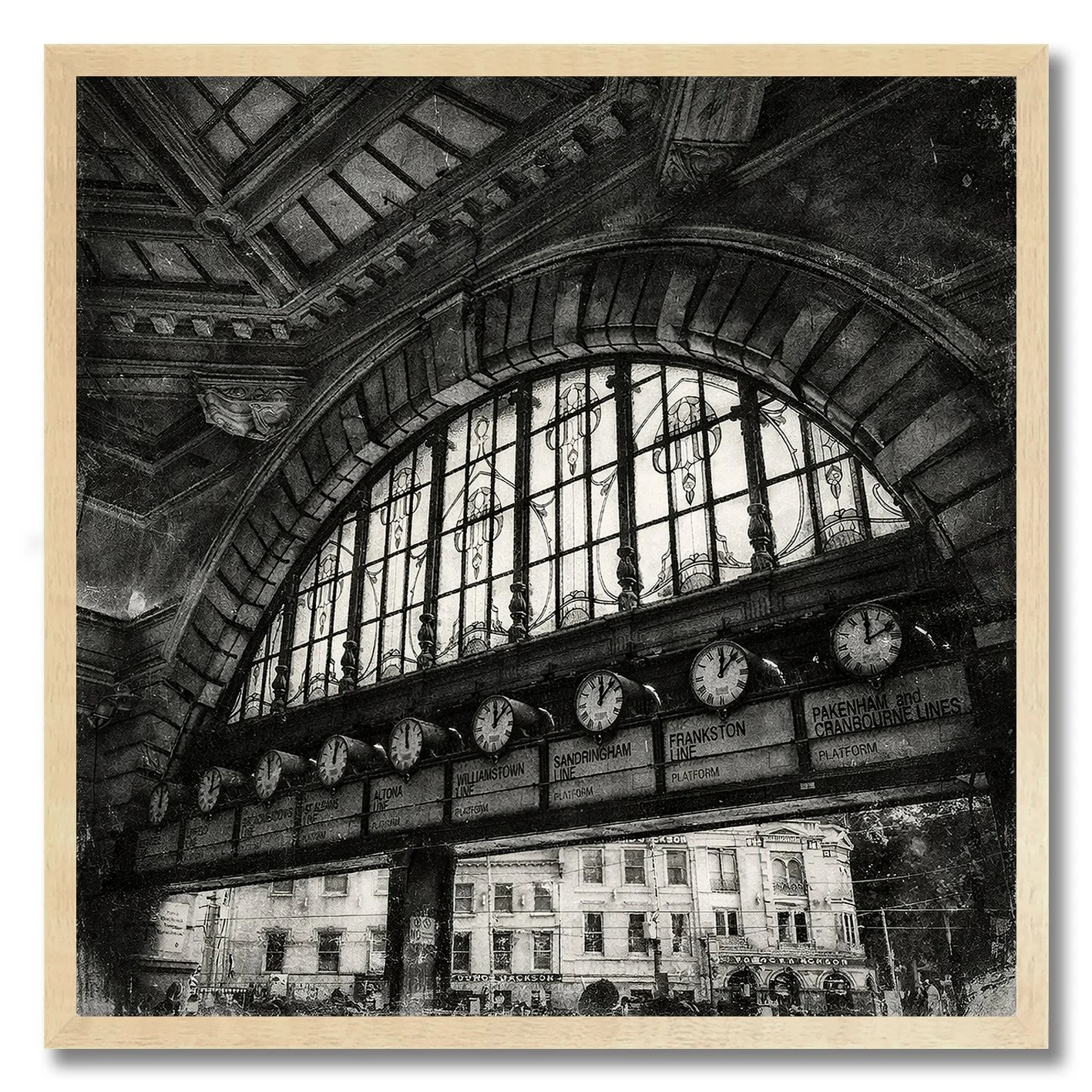 Black and white photograph of Flinders Street Station clocks under arched window