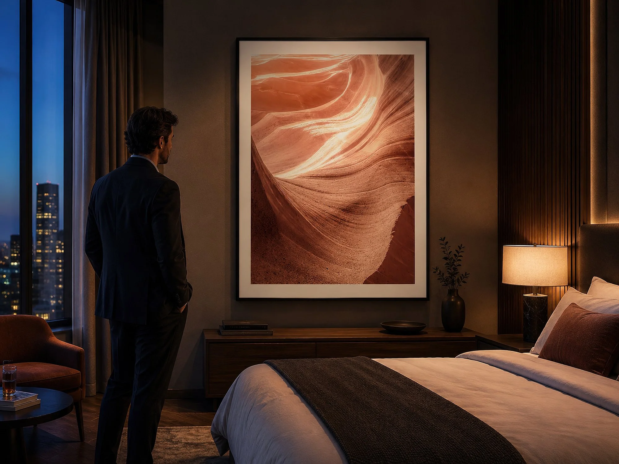 Framed Antelope Canyon photograph displayed in a warmly lit modern bedroom with a man standing nearby.