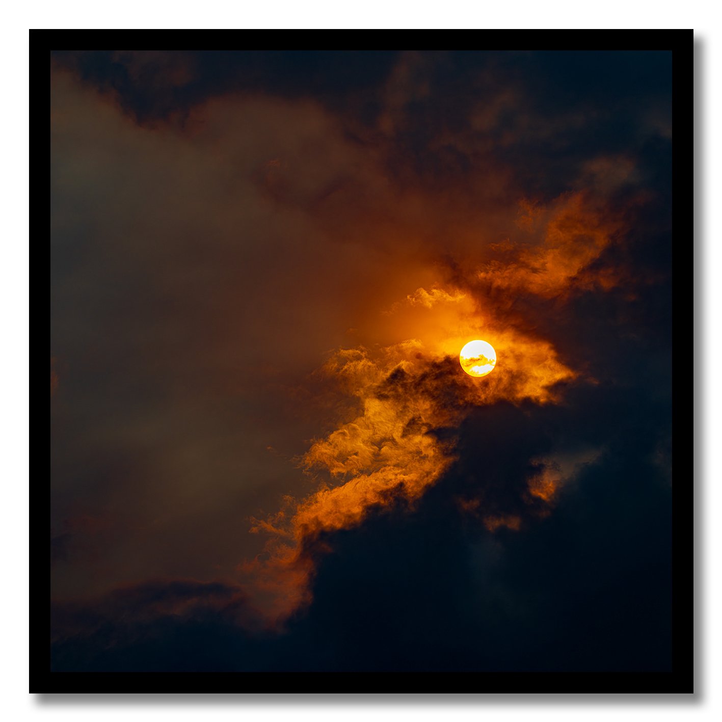 Sun breaking through golden clouds in a dramatic fine art photograph
