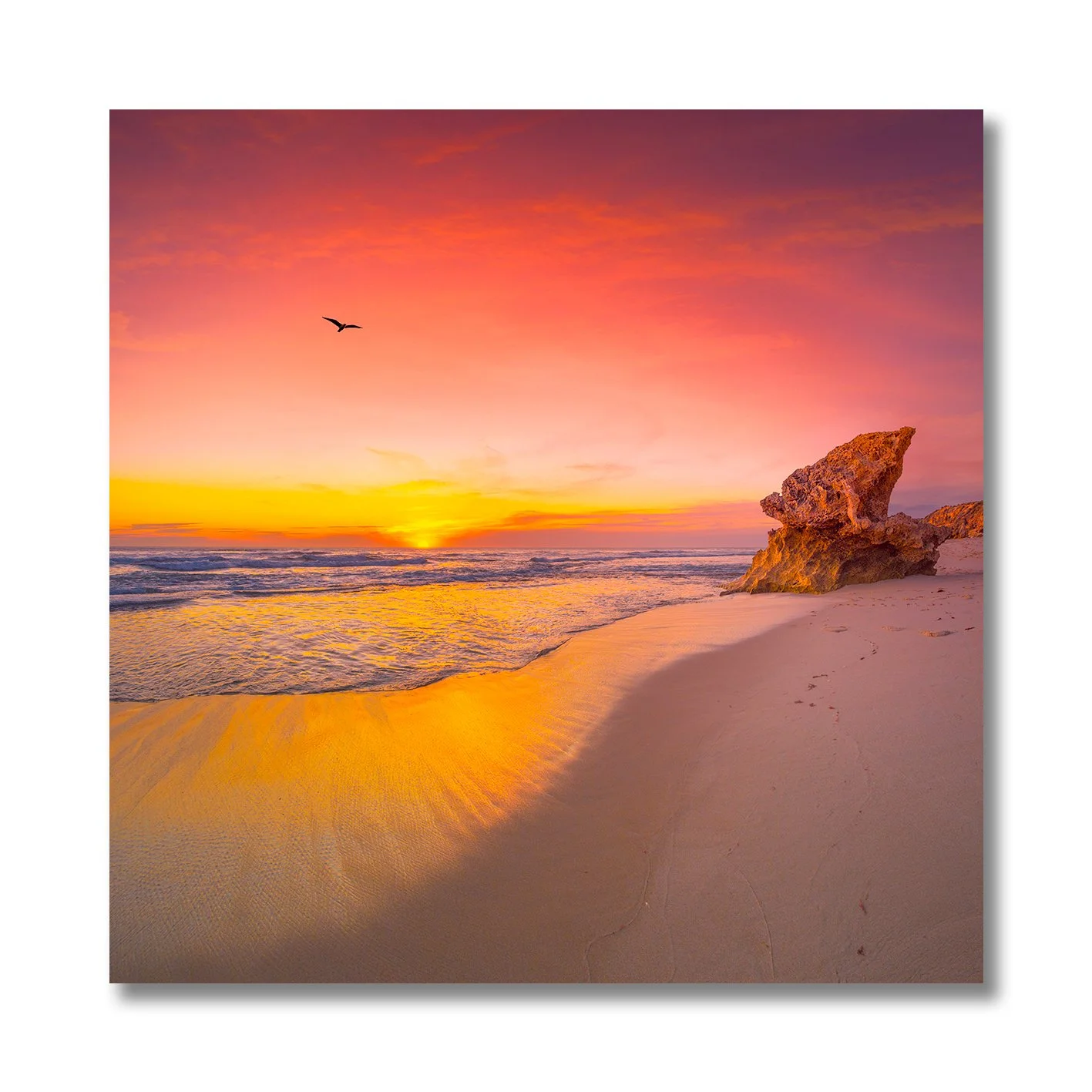 sunset photograph of rye back beach with glowing sand and rock