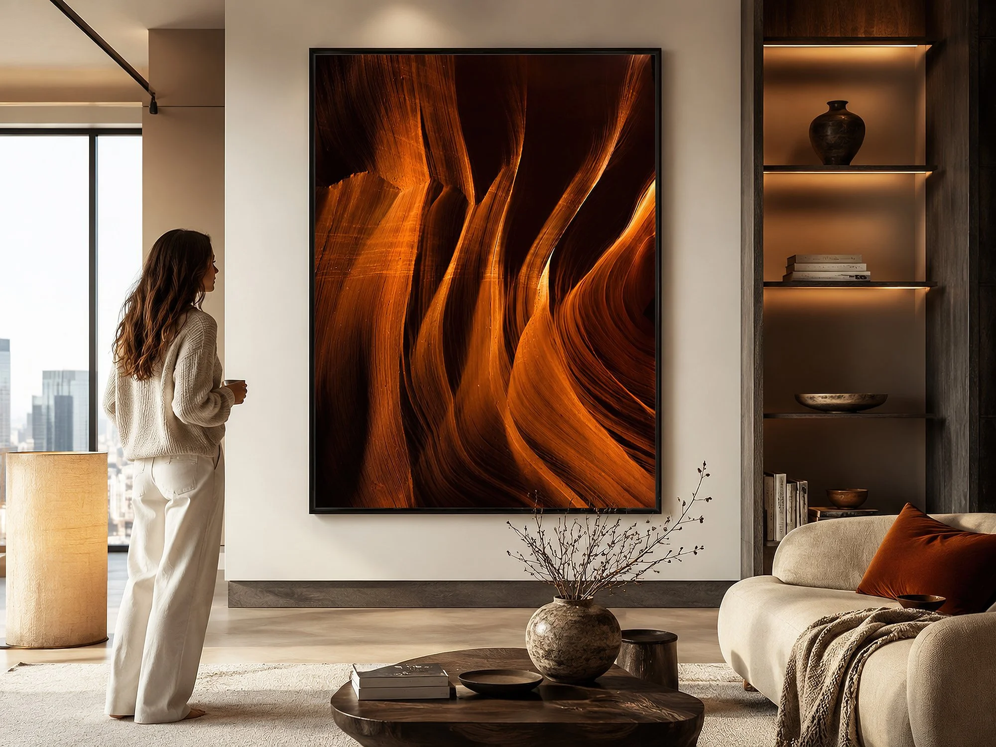 Framed Antelope Canyon photograph displayed in a modern living room with a woman standing nearby.