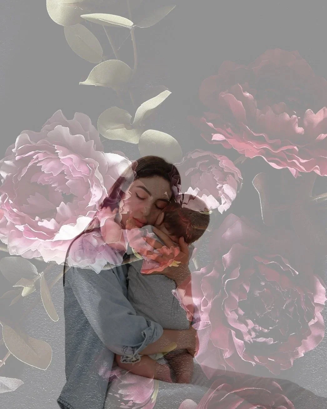 Brown haired mother holding her baby with a pink floral background