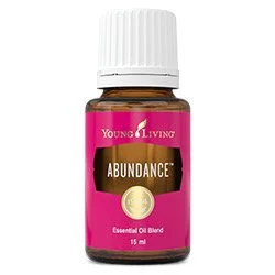 A 15ml bottle of Young Living Abundance essential oil blend with a pink label and white cap.