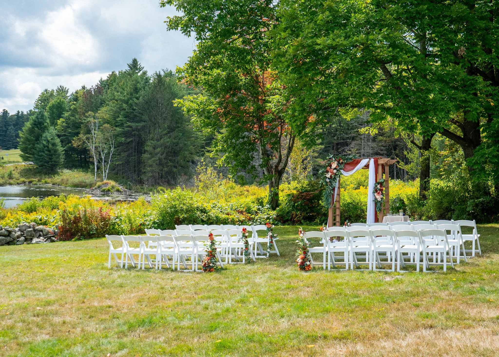 A beautifully decorated alter with chairs set up for a wedding