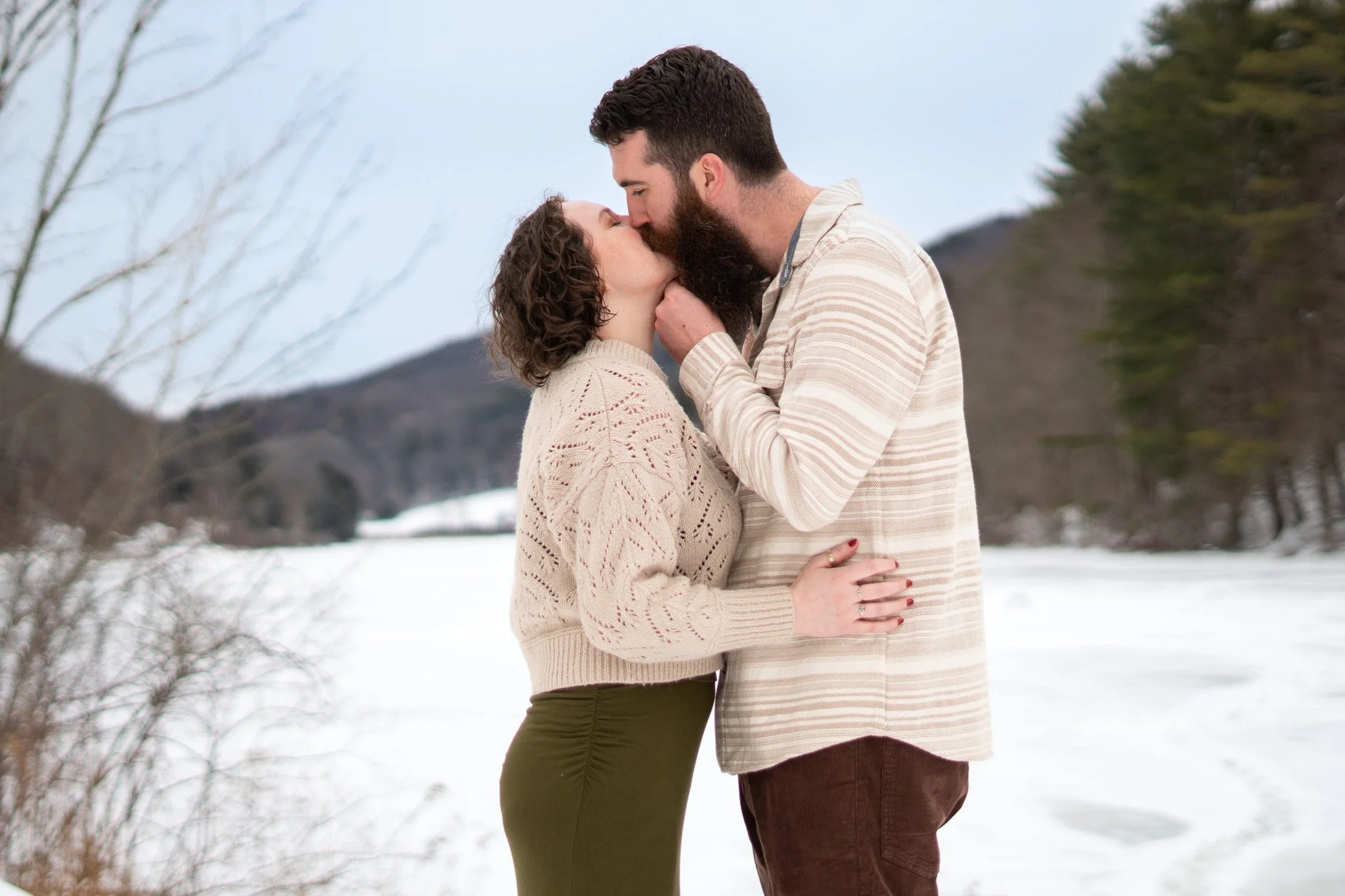 Aubrey and Tyler share a kiss at Sweet Pond in Guilford, Vermont during their engagement photo session with Clover and Pine Photo. Southern Vermont Wedding Photographer.