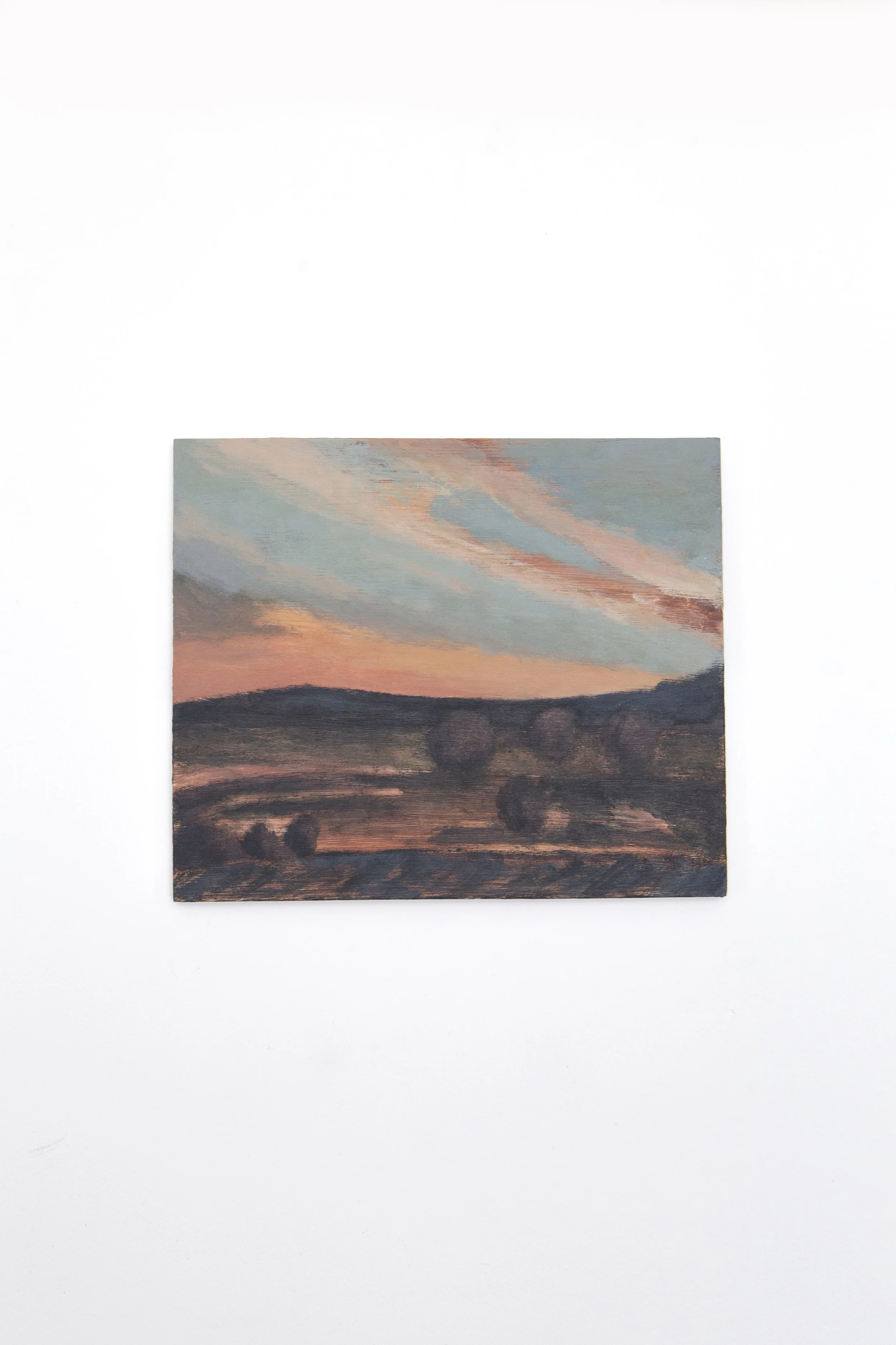Oil painting of a sunset over a landscape with rolling hills and scattered trees, featuring pastel sky with pink and blue clouds.