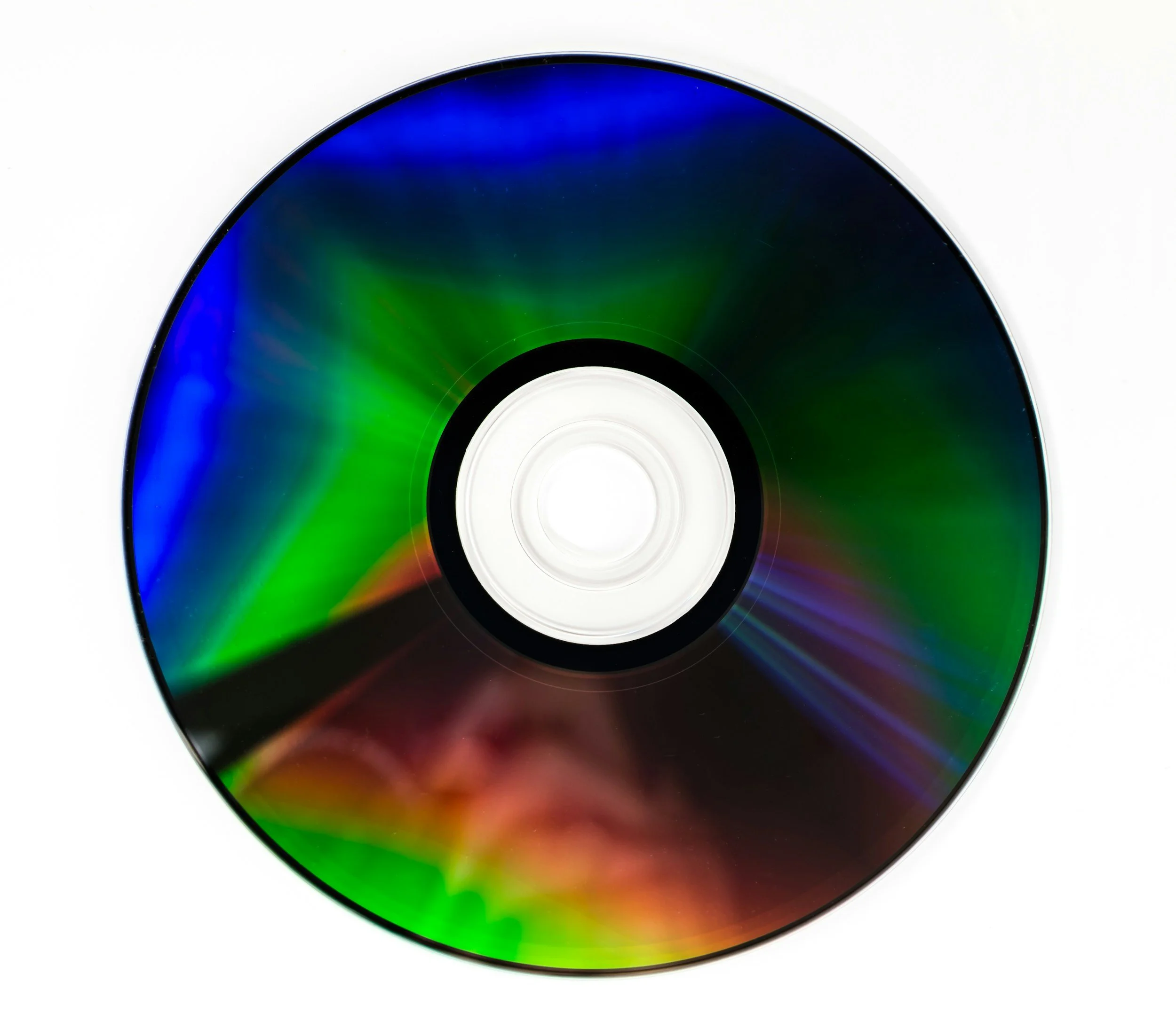 Compact disc with reflective rainbow-colored surface on a white background.