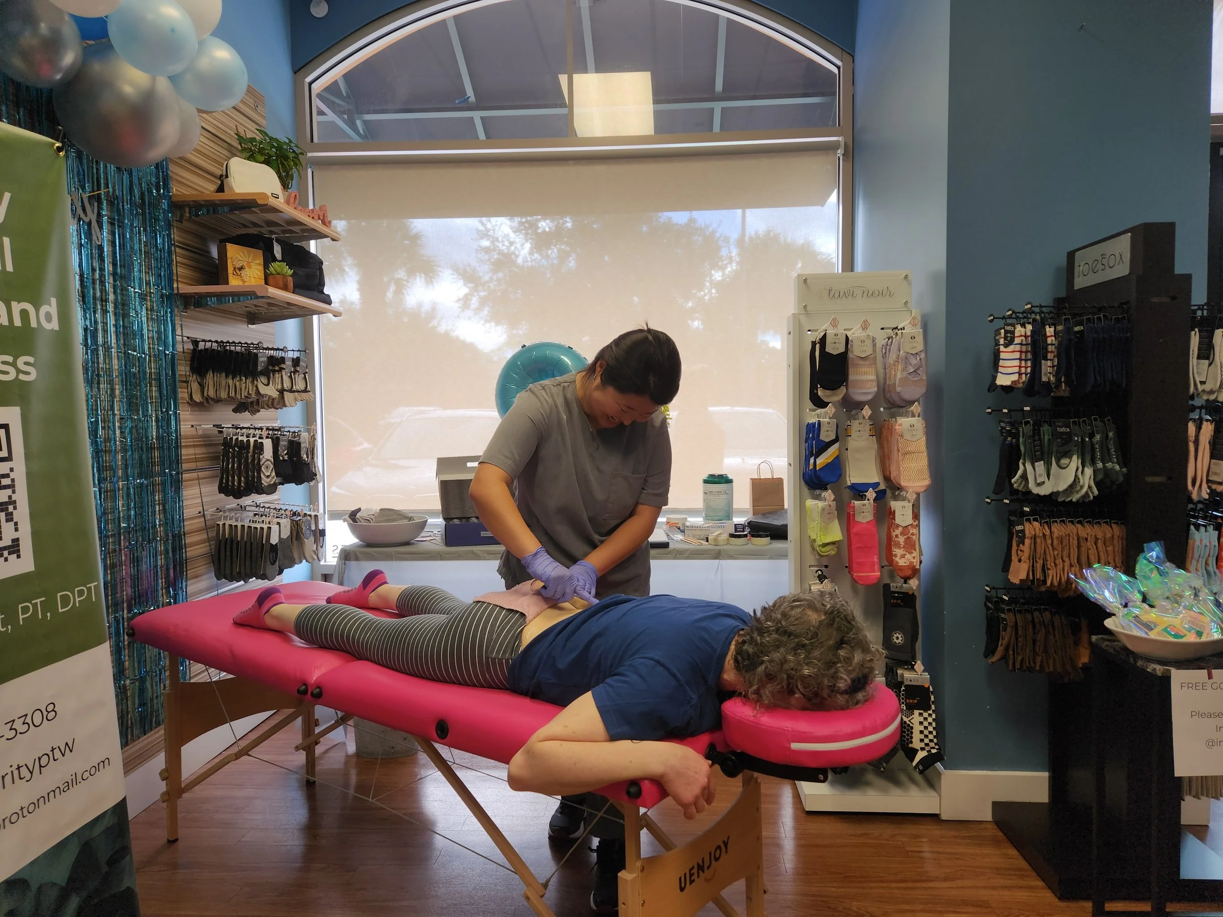 Dr. Karen provides manual therapy to a client at a community event.