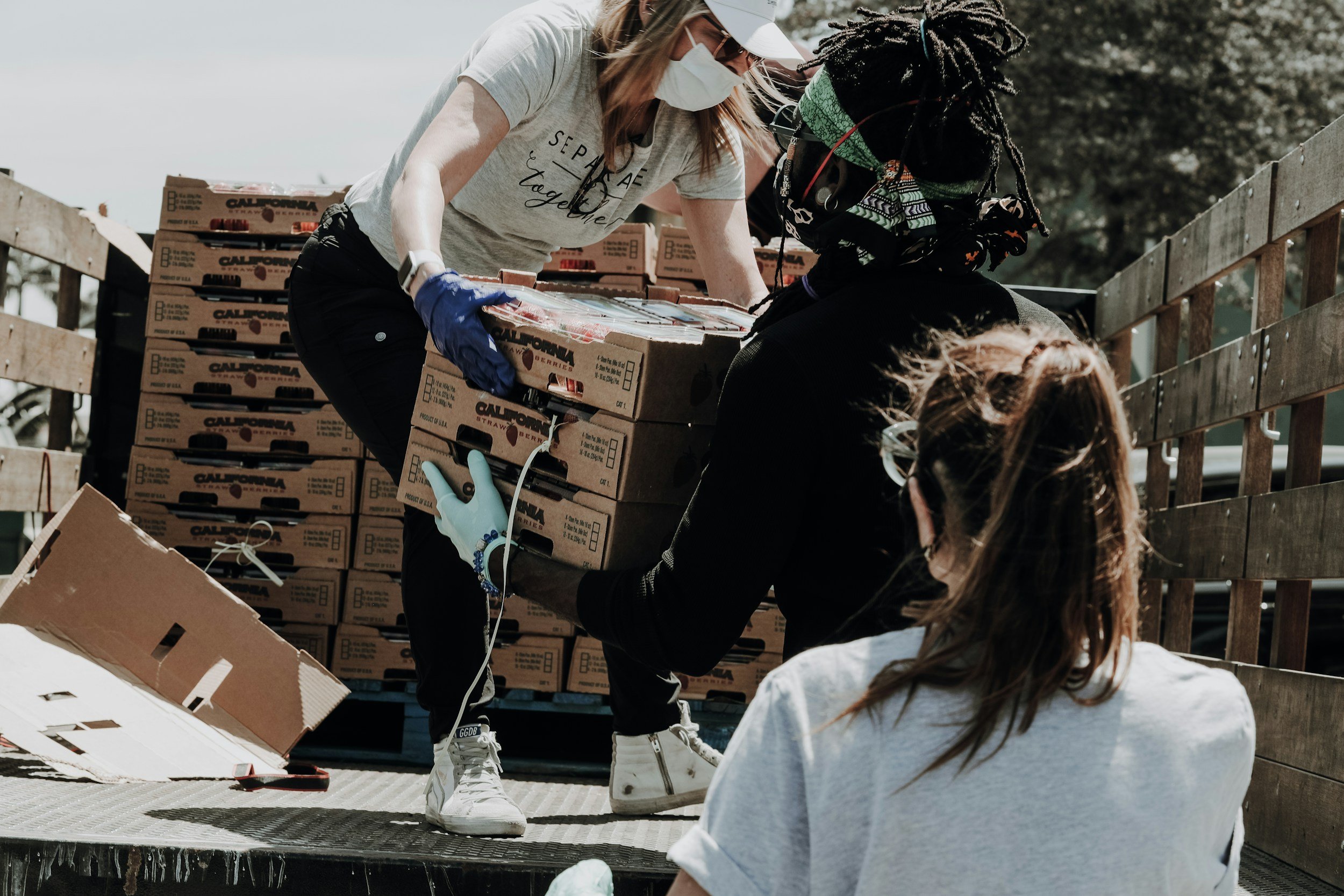 volunteers unload food for  those in need