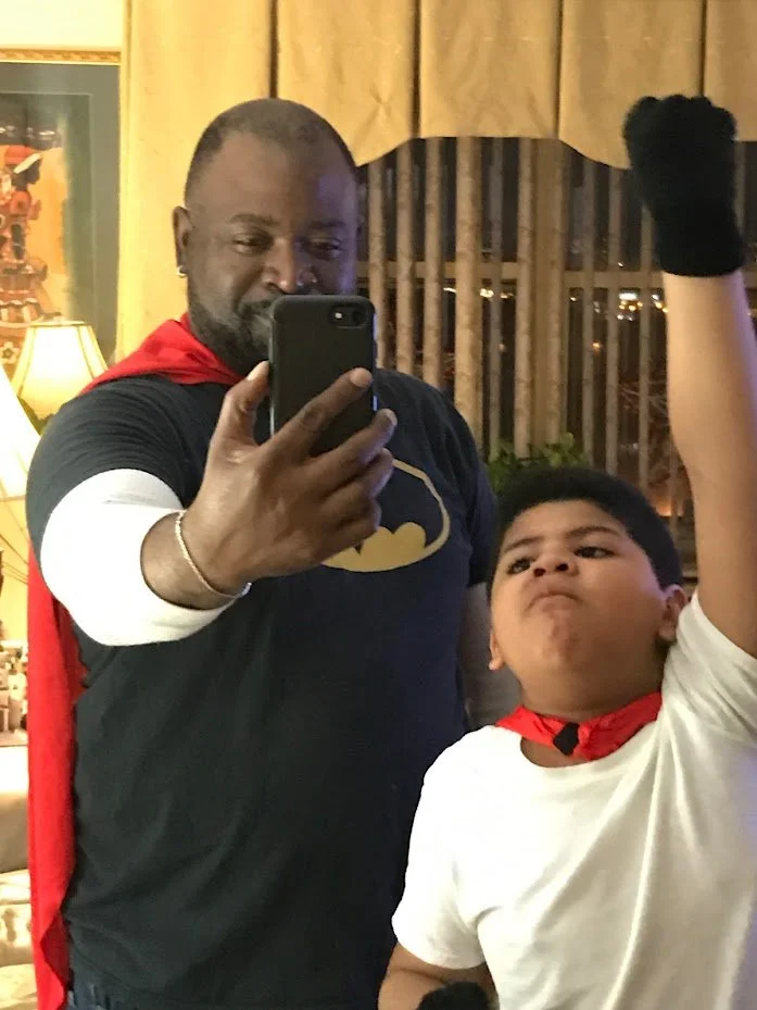 father and son dressed up as superheroes
