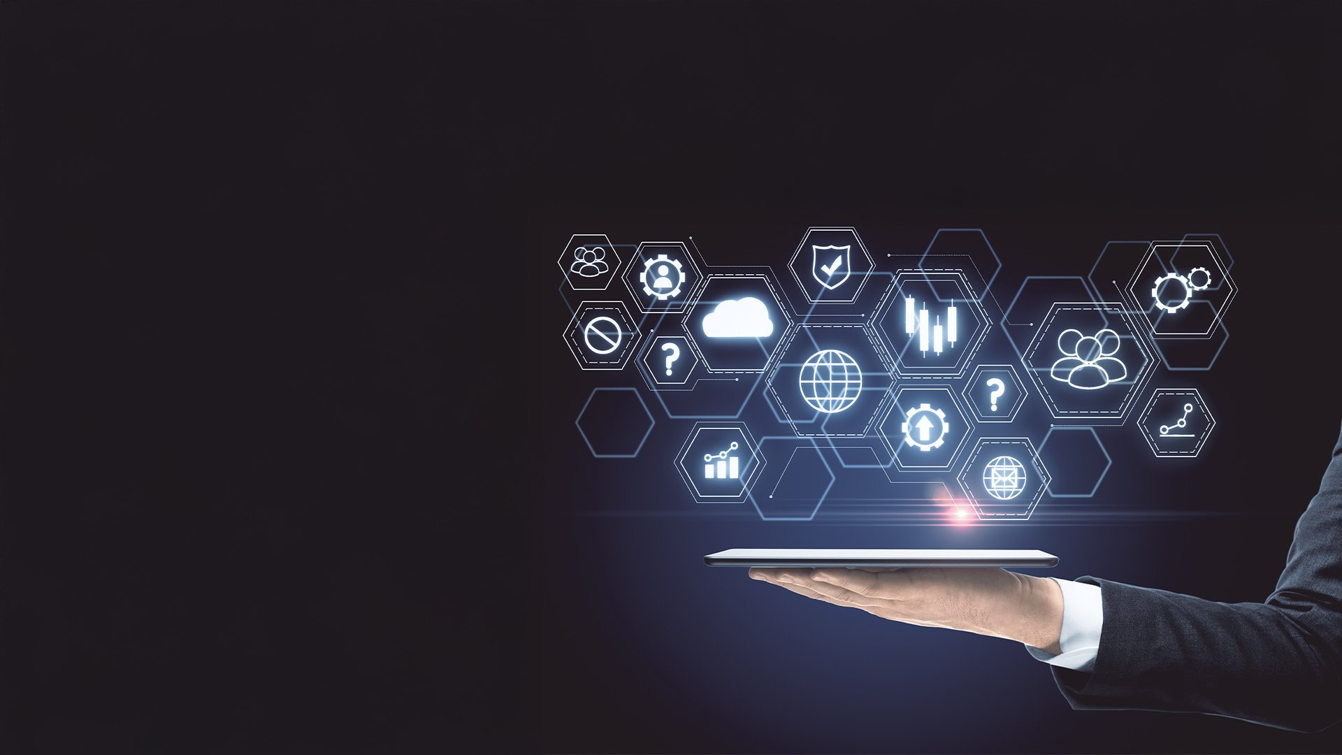 A person in a suit holding a tablet with glowing digital icons and hexagon graphics representing technology and data analysis.
