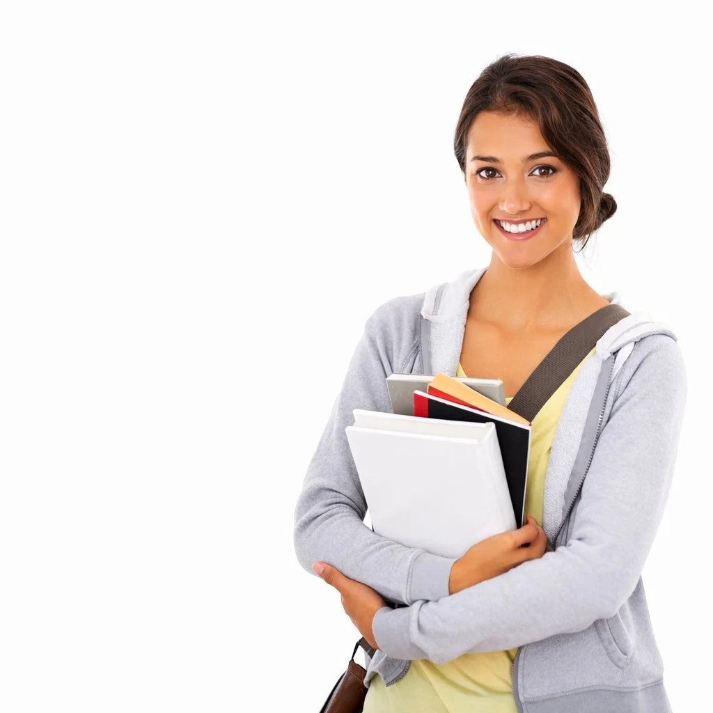 Young woman smiling and holding notebooks and folders, dressed casually against a white background.