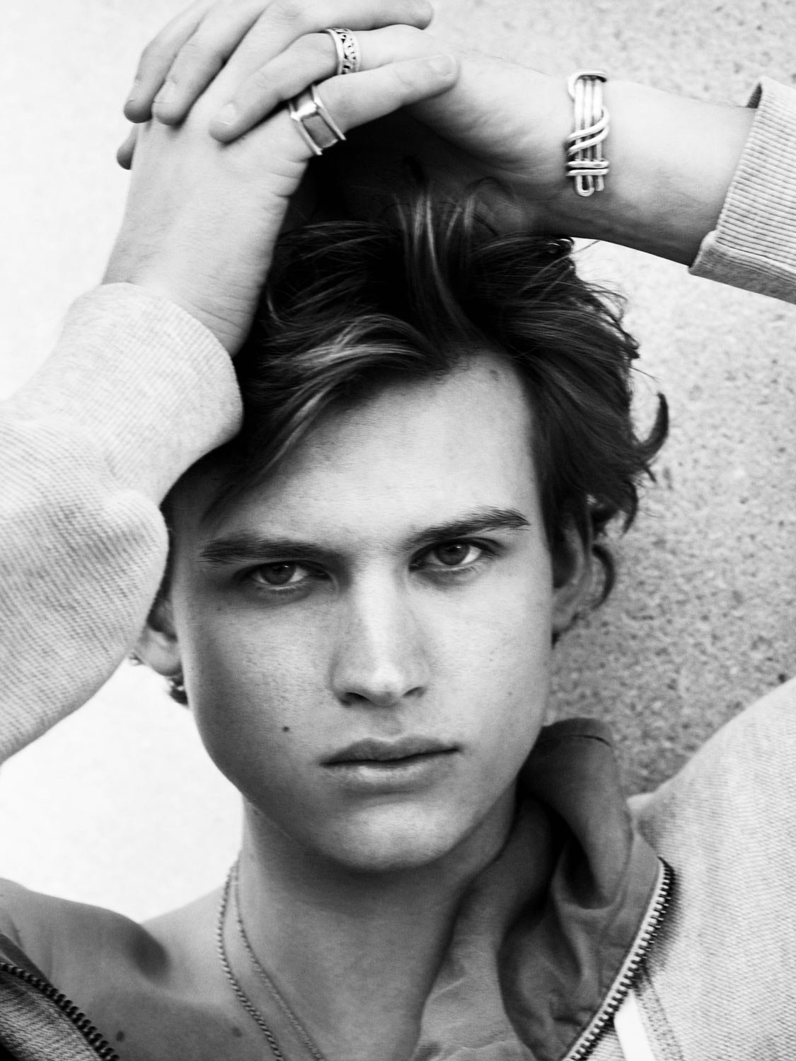 A young man photographed in black and white  wearing a t-shirt.