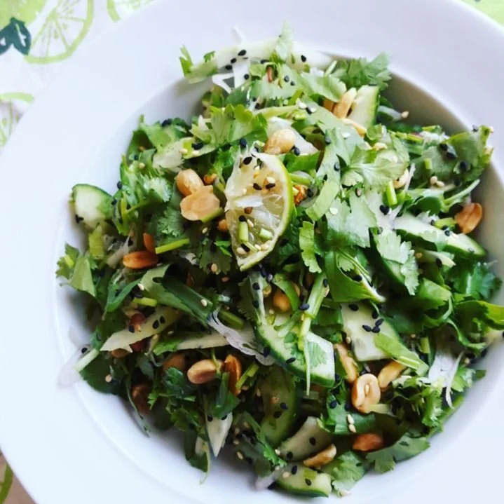 Healthy vegetable salad with cilantro, cucumbers and peanuts.