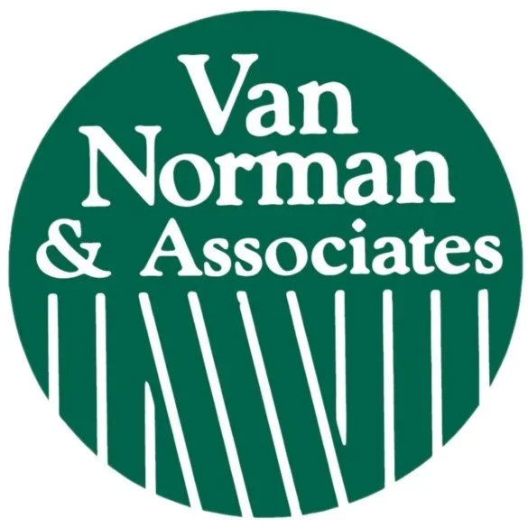 A green circular logo with the text 'Van Norman & Associates' in white, with vertical white lines at the bottom of the circle.