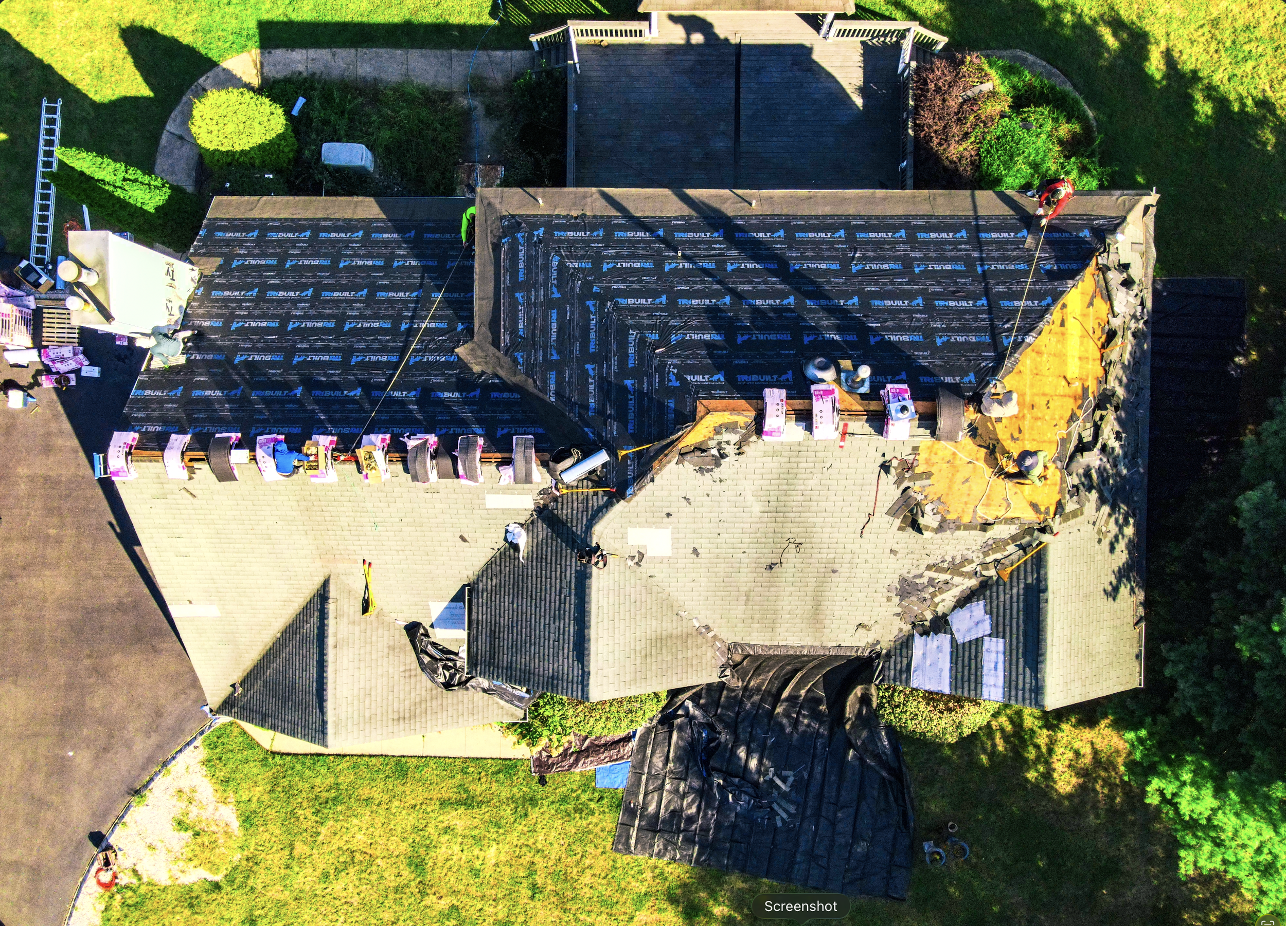 Installing synthetic underlayment.