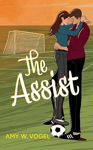 A couple embracing on a soccer field with a goalpost in the background. The title 'the Assist' is written in large white letters, and the author's name, Amy W. Vogel, appears at the bottom in yellow. It is an indie author book.