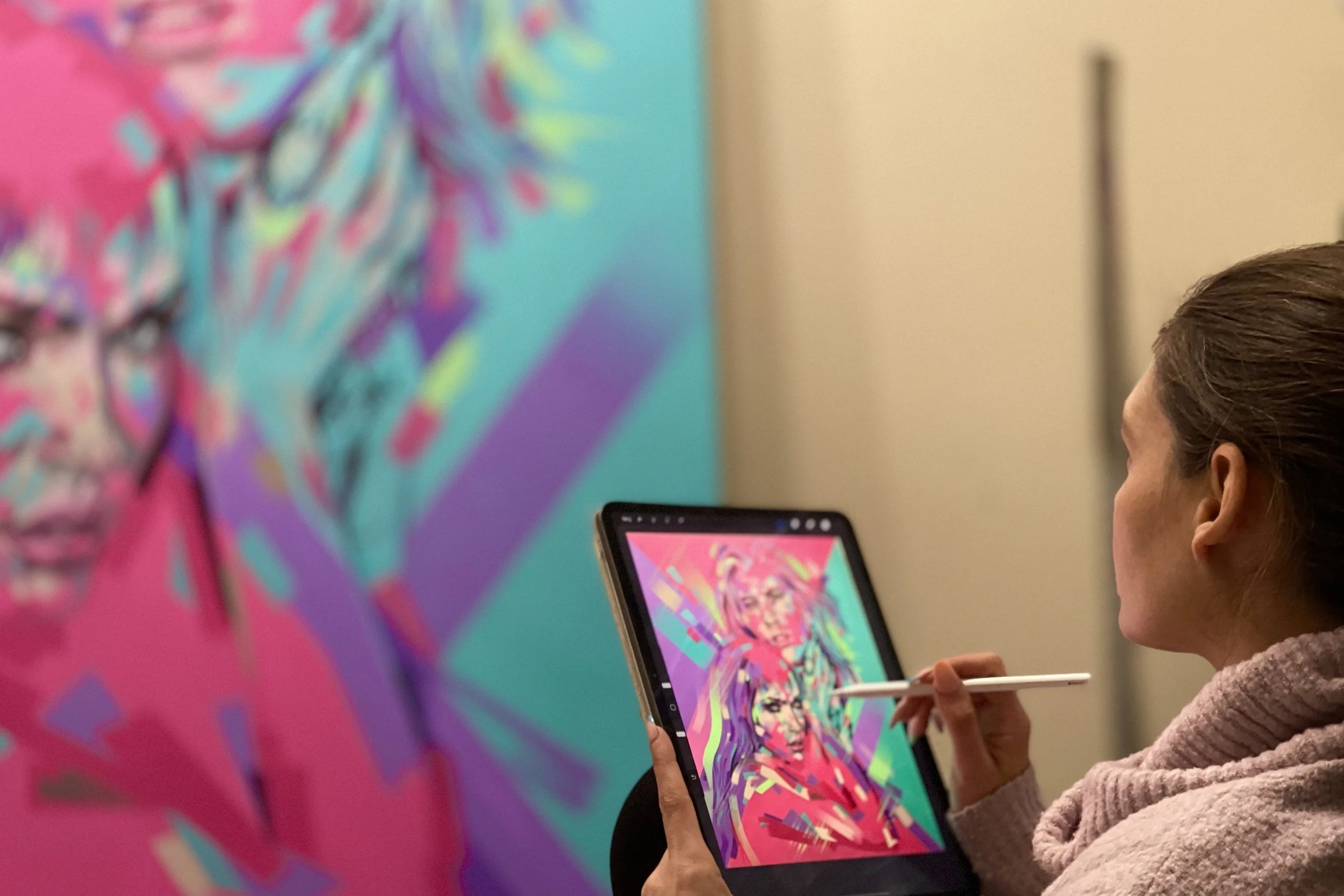 Artist Michelle Kohler designing a private commission on her tablet