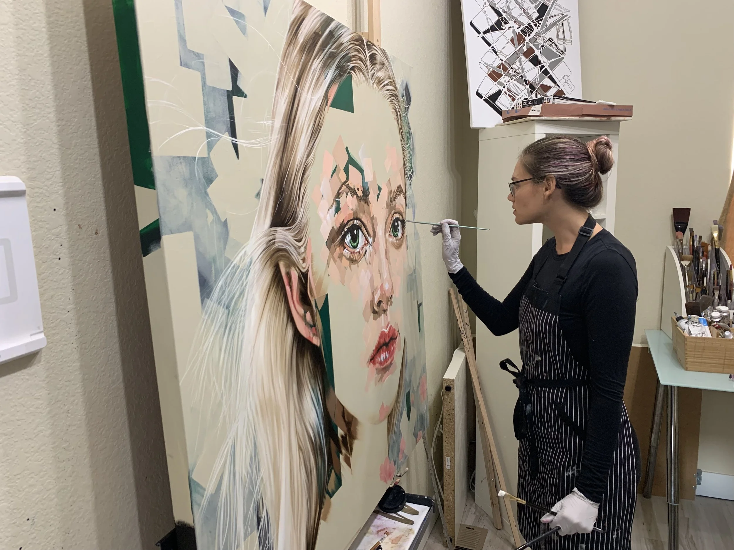 Michelle Kohler painting L'Innocent in her studio