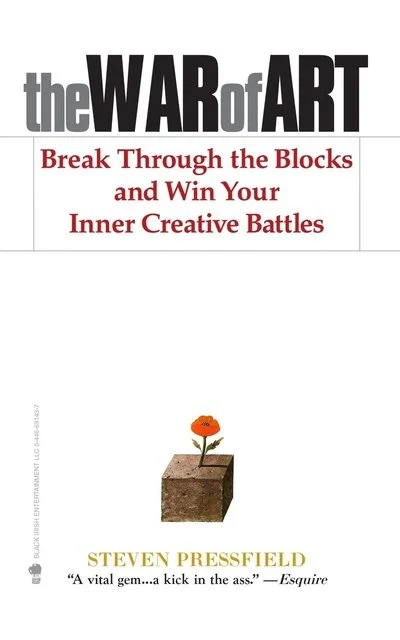 Book cover titled 'the WAR of ART' with subtitle 'Break Through the Blocks and Win Your Inner Creative Battles' by Steven Pressfield, featuring an illustration of a flower growing from a brick.