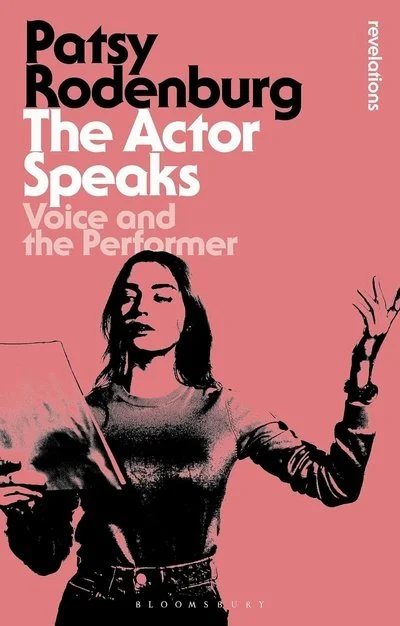 Book cover for "The Actor Speaks" by Patsy Rodenburg with a pink background and a black and white illustration of a woman holding a script or paper, gesturing with her right hand.